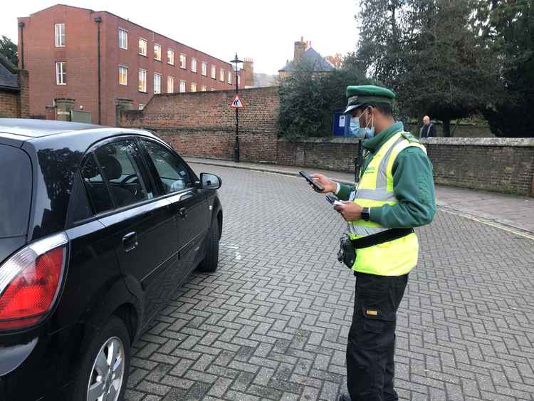 Parking attendant. The council is working to root out 'fake' attendants