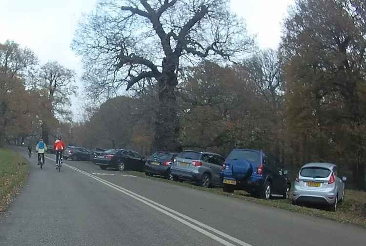 Cars parked on the grass off Broomfield Hill in Richmond Park - photo by @alxwtsnwrk