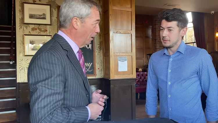 Nigel Farage, left, speaking with Waterman's Arms manager Adam Sandford