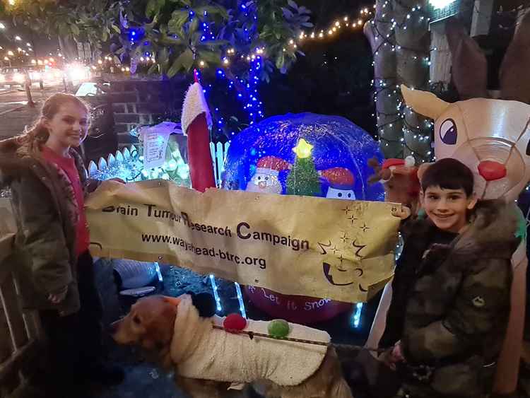 Young Daisy and James with the charity banner