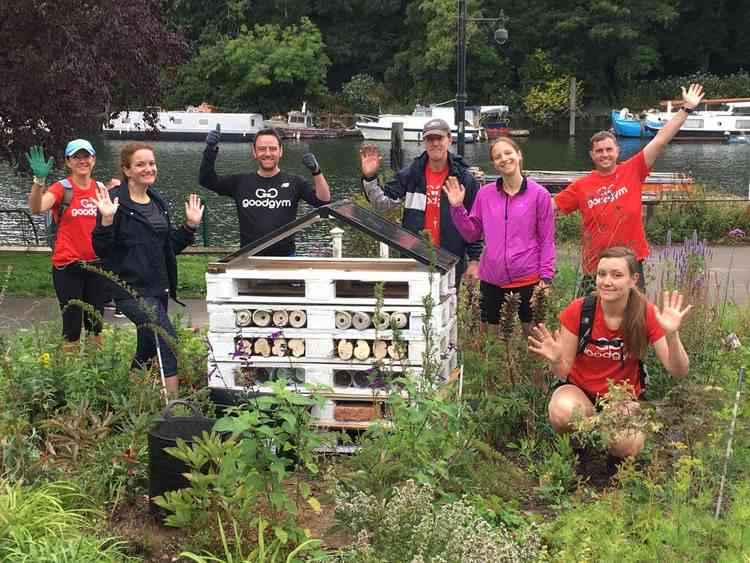 GoodGym Richmond members cheering the completion of a stage in the Richmond Riverside insect hotel's construction