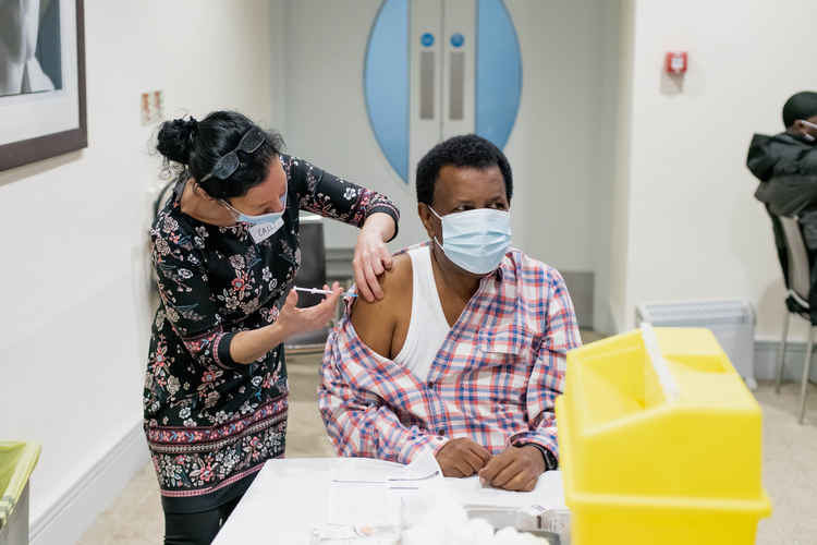 Mohammed Nair receives the coronavirus vaccine