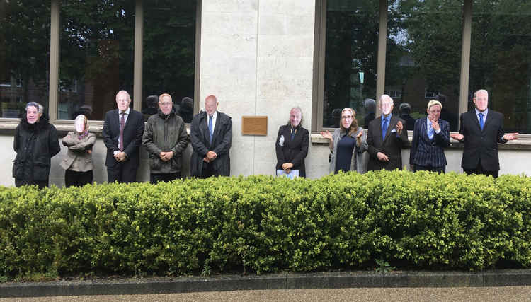 Campaigners unveiled a plaque showing nothing to represent Dorset Council's perceived lack of action on the climate emergency and posed wearing masks of Cabinet members