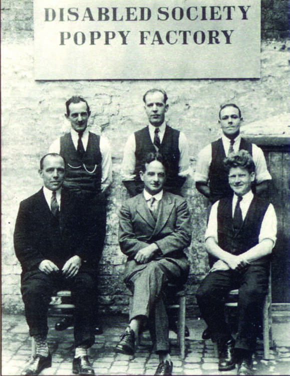 George Howson (bottom centre) with his employees at the first Poppy Factory opened in an old collar factory in Bermondsey