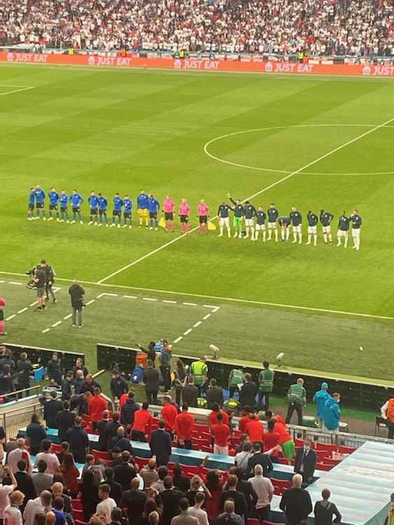 Lineup: both teams sing their national anthems (Image: Stuart Higgins)