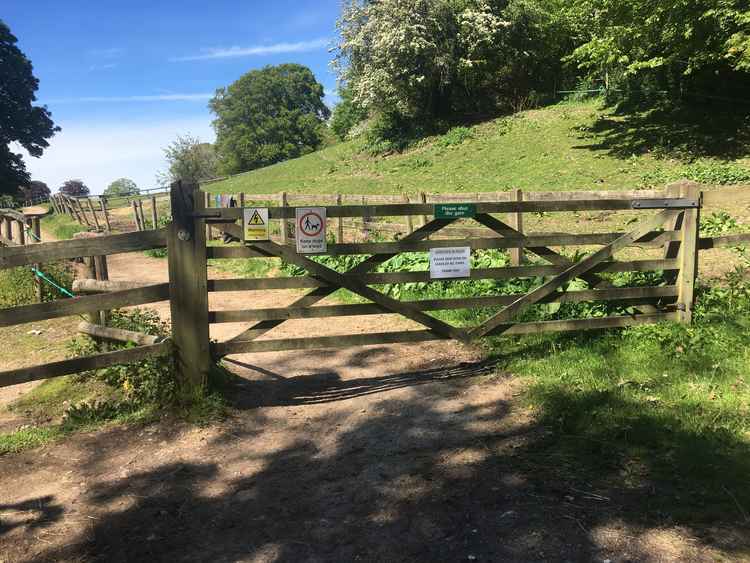 Go through the gate and along the path with paddocks and horses on each side