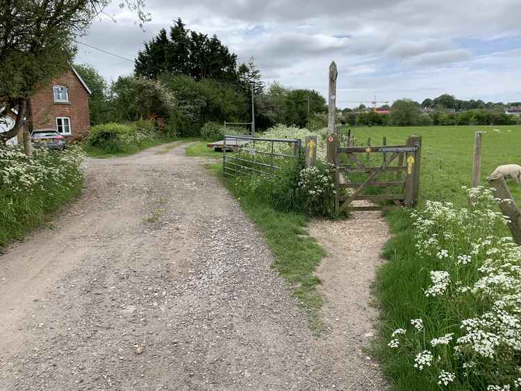 Take the footpath to the right, opposite the house