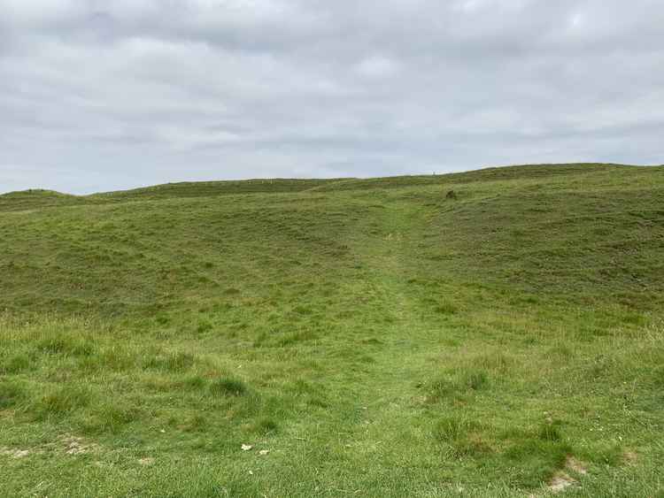 You reach Maiden Castle, enjoy exploring the Iron Age hill fort