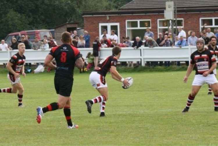 Joe playing for Teignmouth RFC, holding the ball. Picture: Lorna Gray
