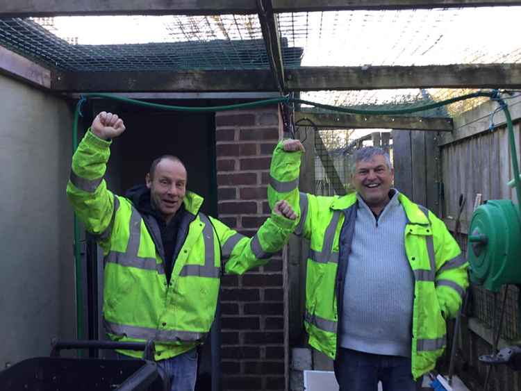 Wardens Don and Steve jubilant after releasing the swan from quarantine