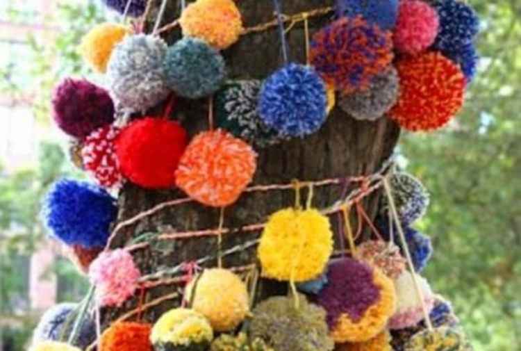 Pompoms can form part of yarnbombing decorations