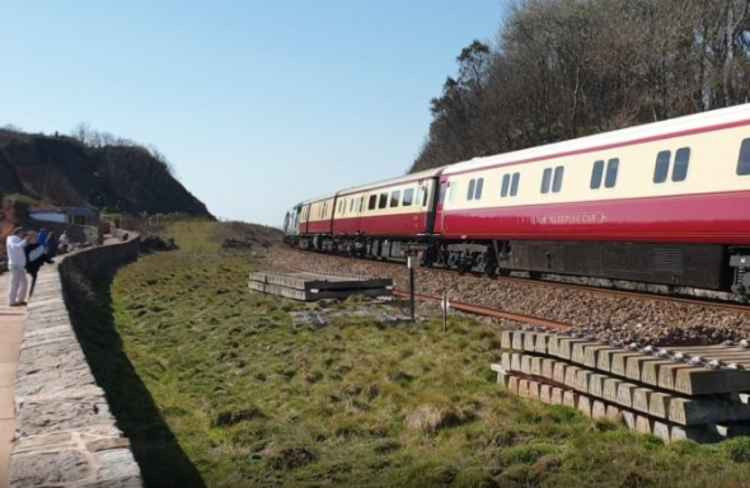 Trainspotters gathered by the track to watch the unusual train pass through. Picture by Colin Campbell