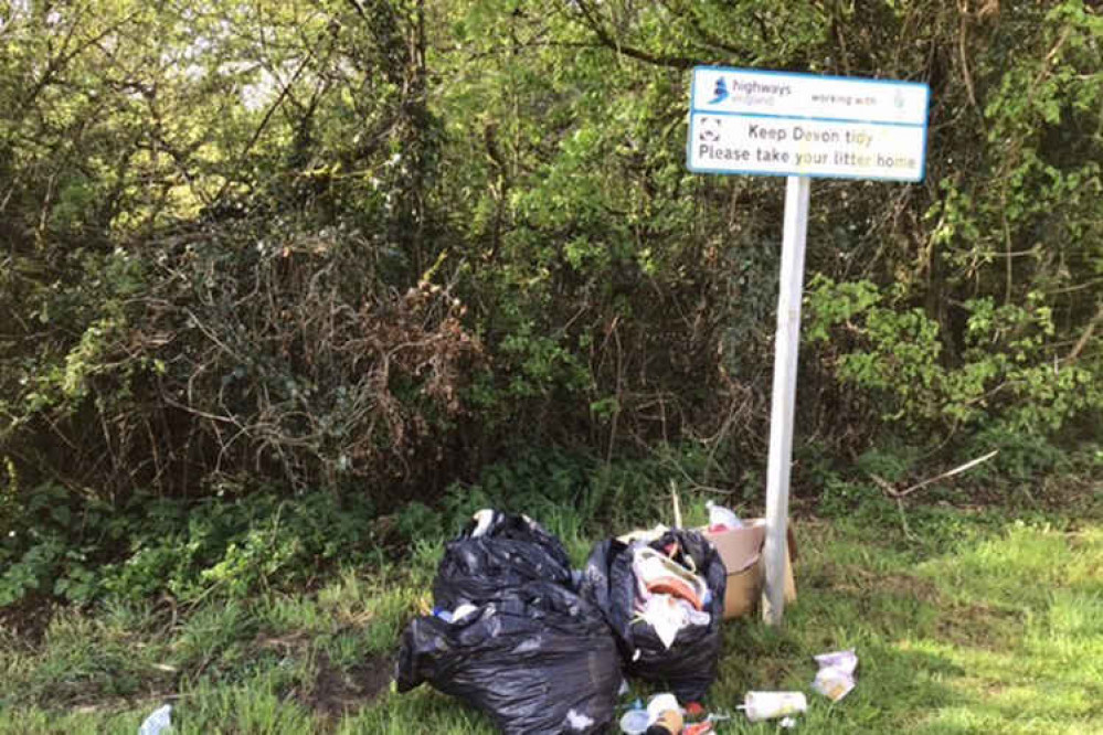 Litter left in an A30 layby near Okehampton, at the foot of a Highways England 'Keep Devon tidy' sign