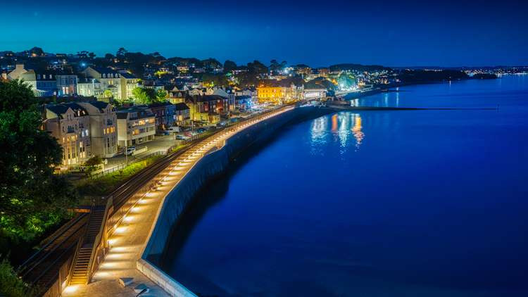 The first section of Dawlish's new sea wall at night, showing the new lighting. Picture from Network Rail