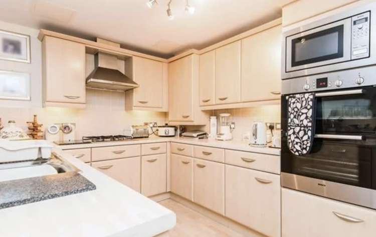 The flat has an open-plan kitchen with all appliances fitted, including a breakfast bar. Credit: Fulfords