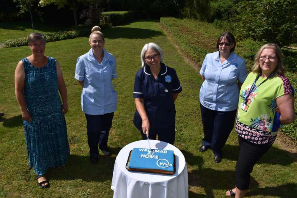 Members of the team celebrate the new Weldmar at Home service with a special cake