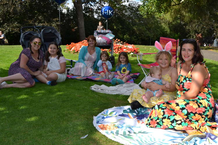 Families from Damers First School enjoying the Mad Hatter's picnic in the Borough Gardens