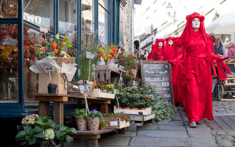 Extinction Rebellion Red Rebels arrive at the October Frome Independent Market