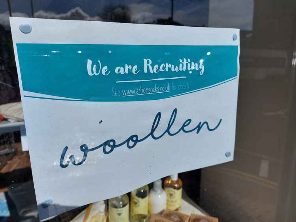 This job is advertised in the window of the woolen shop on Badcox in Frome