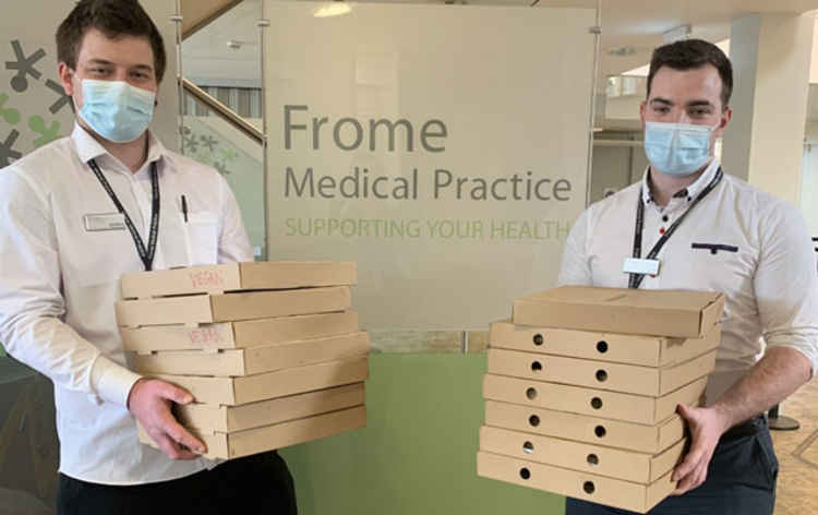 Johnnie and Josh helping distribute pizza to the FMP team - one of the many thank you gifts the practice is grateful to have received