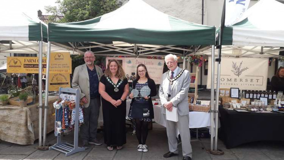 Left to right: Cllr Damon Hooton, Mendip District Councillor, Cllr Helen Sprawson-White, Chair of Mendip District Council, Gabrielle Martin-Goff of Sew Little, Winner of the NMTF Young Traders Market South West Regional Final and Michael Nicholson, Presid