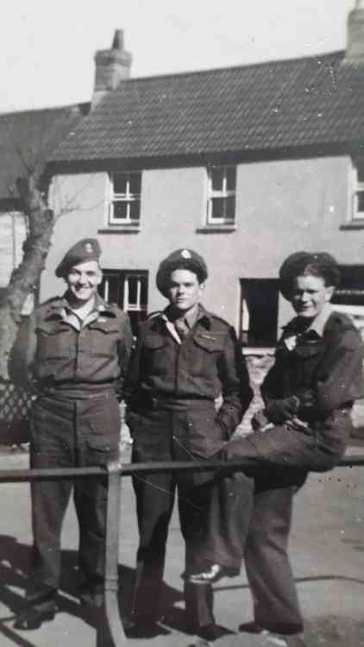 Lawrence (on the right) sat with two pals on the railings in Midsomer Norton when he came home on leave