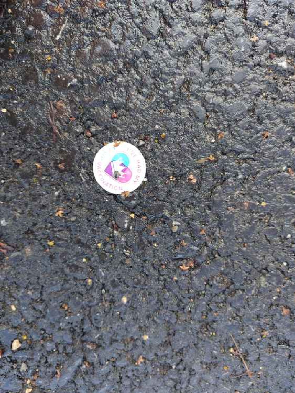 A coronavirus vaccine sticker on the ground outside Midsomer Norton's Somer Centre January 21