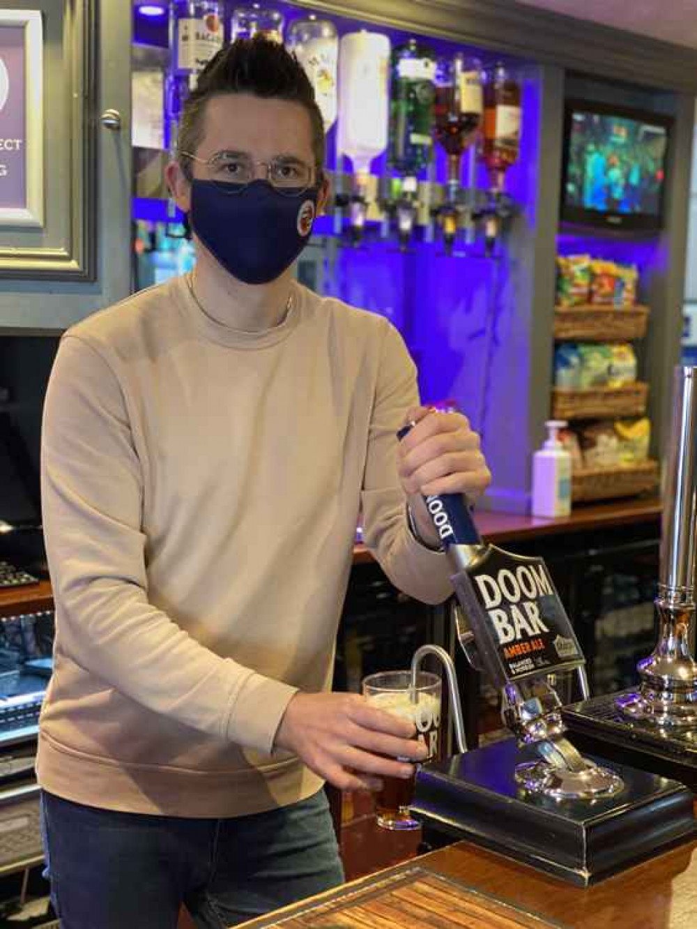 Cllr Grant Johnson serving behind the bar at Paulton Rovers FC.