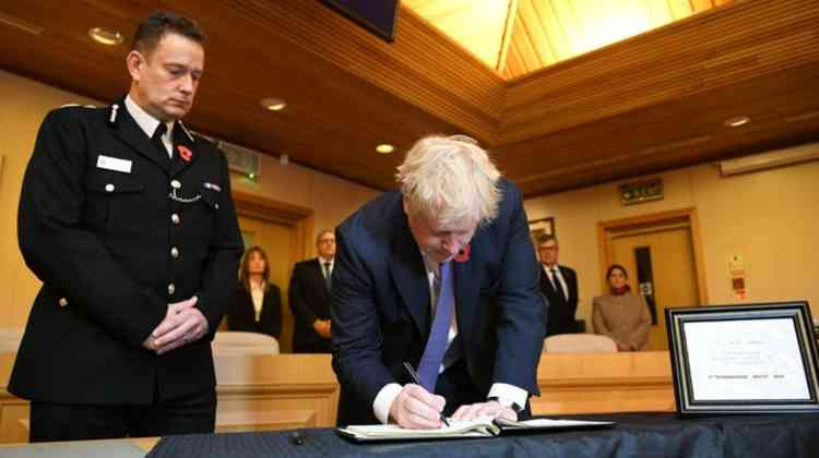 PM Boris Johnson signs the book of condolence