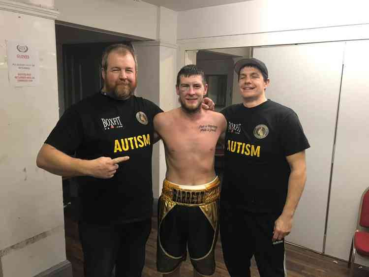 Tom Barrett flanked by West Thurrock Boxing Club's Matt Stanton and head trainer Gareth Lawrence.