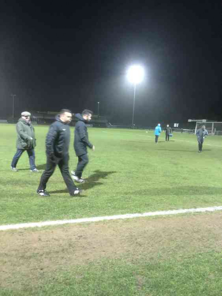 Ref Luigi Lungarella leaves the pitch after calling off the game.