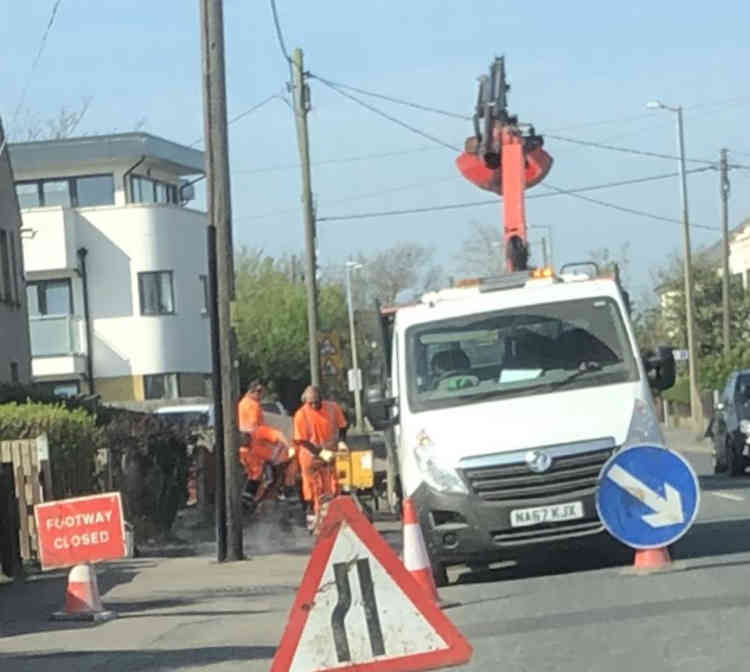 A team of council workers in close proximity as they resurfaced a pavement in Stanford-le-Hope today.