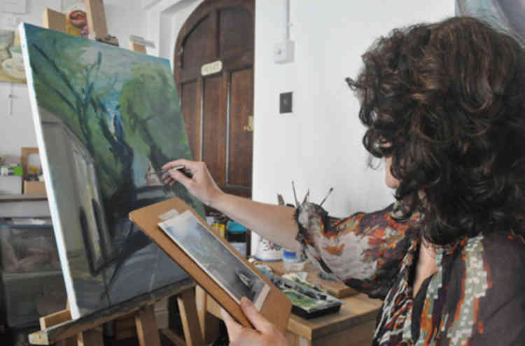Lisa at work on one of her paintings.