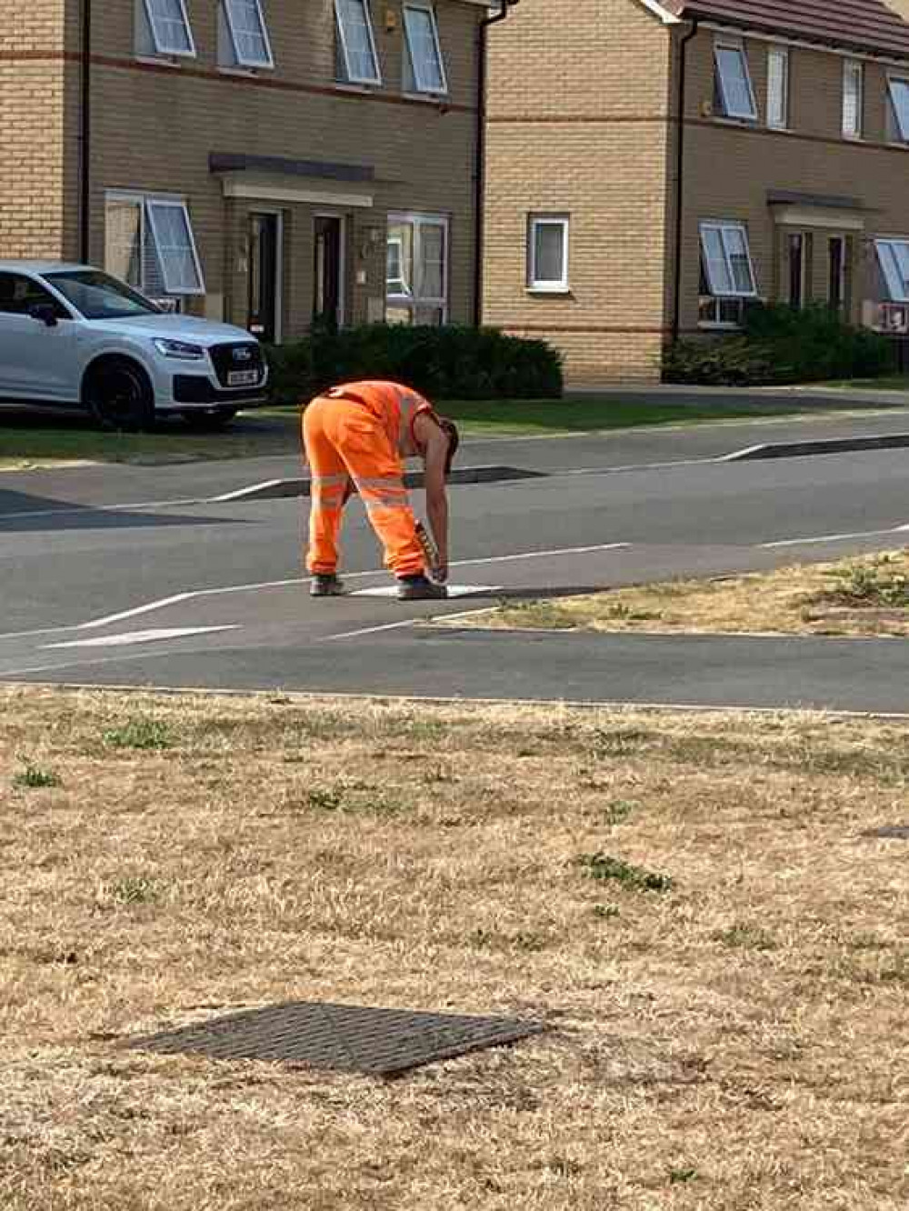 Workers painting signs on pavements on Butts Lane in Stanford-le-Hope today.