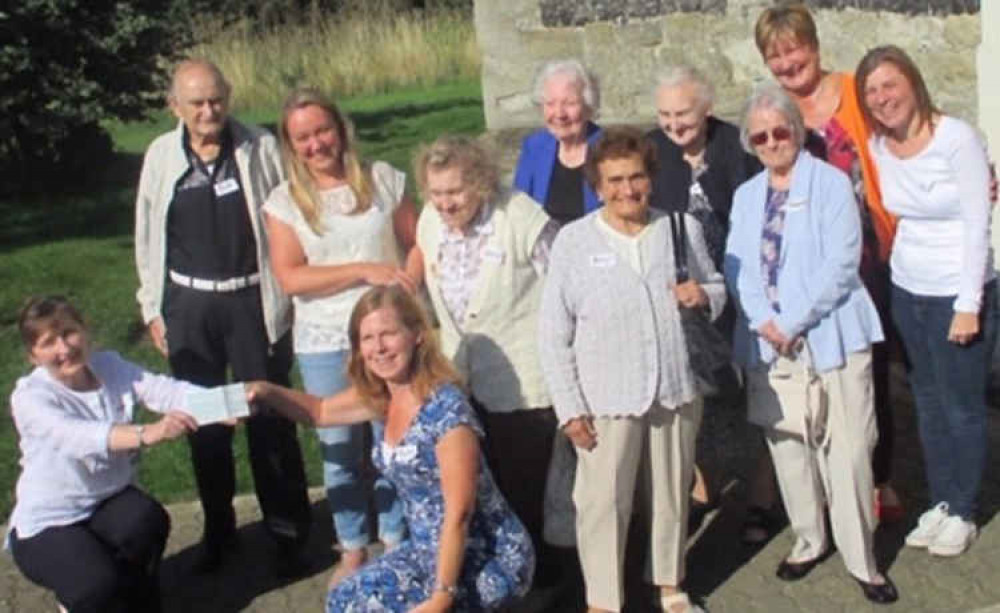 The very first six tea party guests and volunteers with Ira Gill who presented the £200 cheque from Procter & Gamble.