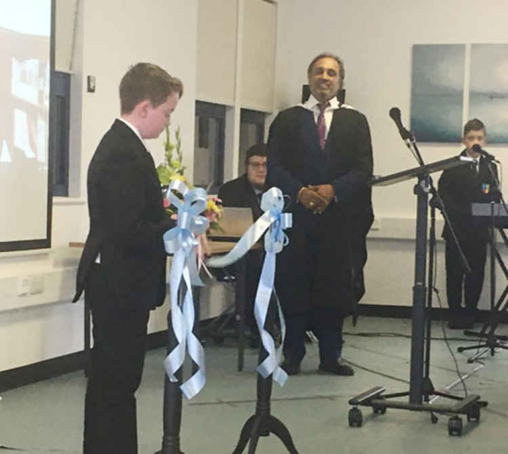 Aiden Dennis officially opens the new school by cutting the ribbon