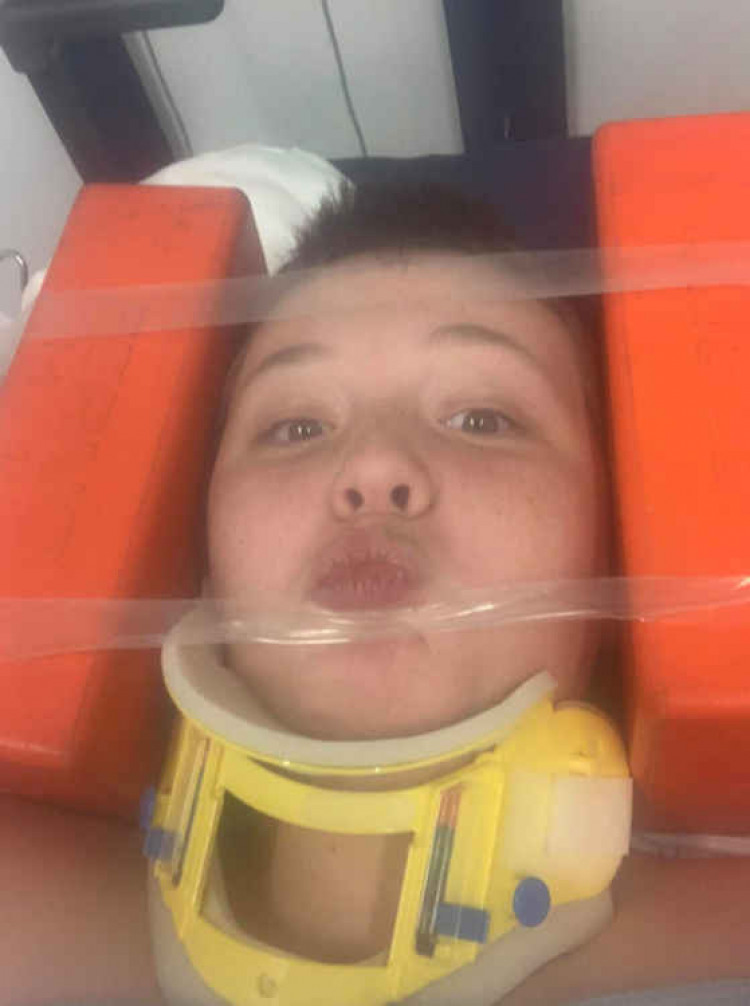 Pucker up! Brave Logan Taylor in hospital.