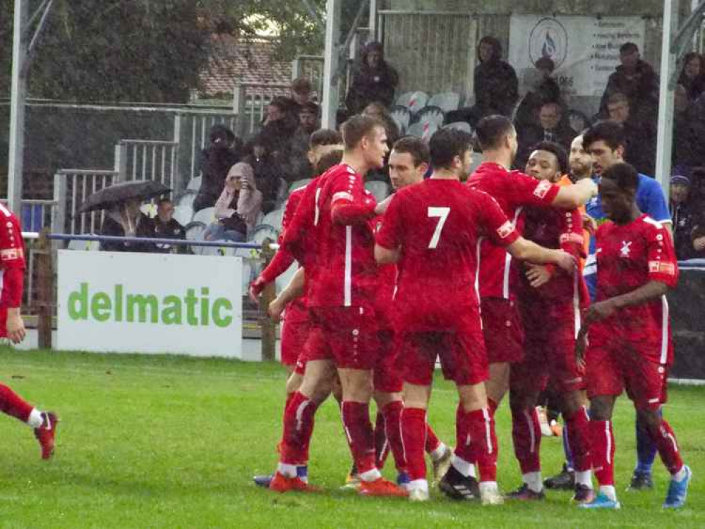 Job done - Aveley celebrate Wyan Reid's successful penalty.