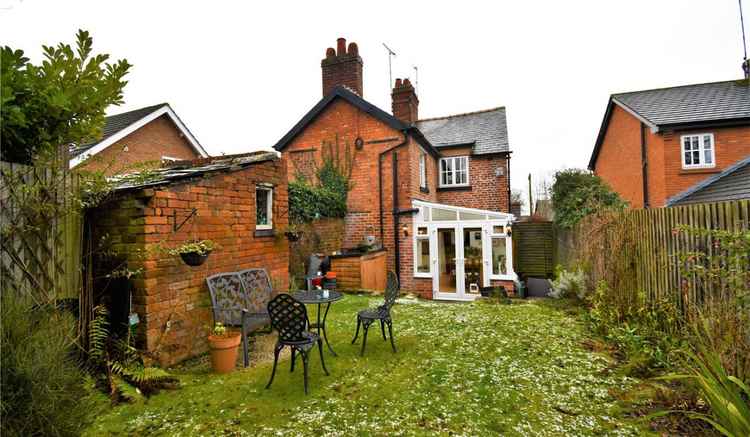 The cottage has an outbuilding