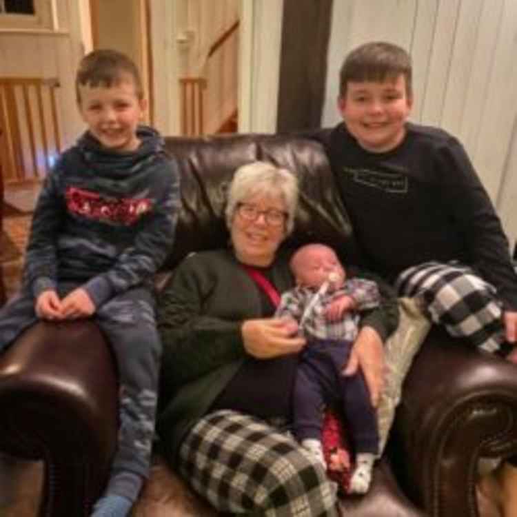 Carol with grandsons Archie, Harry and Jackson on a family holiday in December 2019.