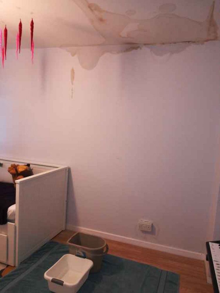 Water drips through the roof into a child's bedroom