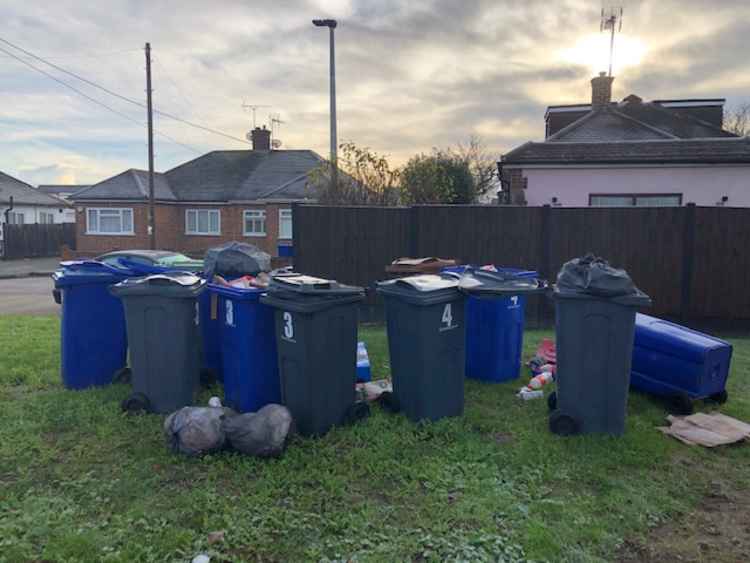 Bins due to be collected have been left many yards from the development and left to stand on grass on London Road.