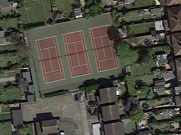 A view from above of the club surrounded by houses.