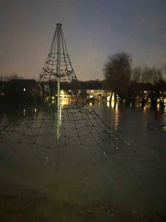 Almost picturesque. The view looking across the flooded Ruskin Road park in Stanford-le-Hope towards Runnymede Road where many houses have been sandbagged as protection against another rise in water levels.