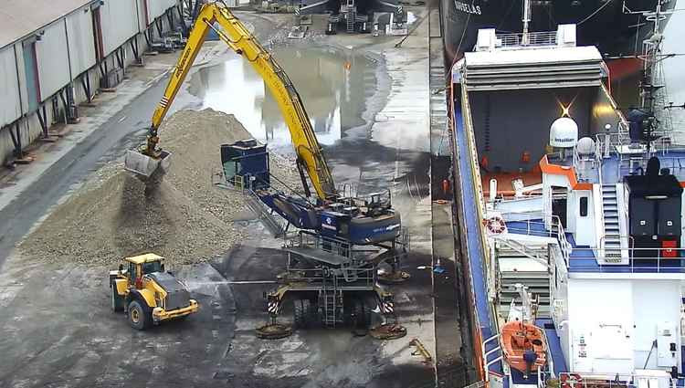 Aggregate being unloaded at the port for processing.