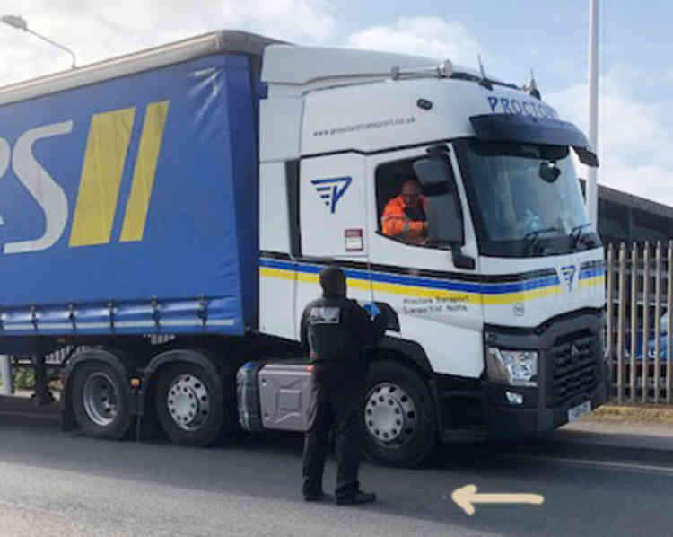 This lorry driver who was parked up on the road on orders of the police while firefighters tackled a blaze dropped his cig butt was collared by an enforcement officer who hid behind another lorry and watched him smoke and drop.