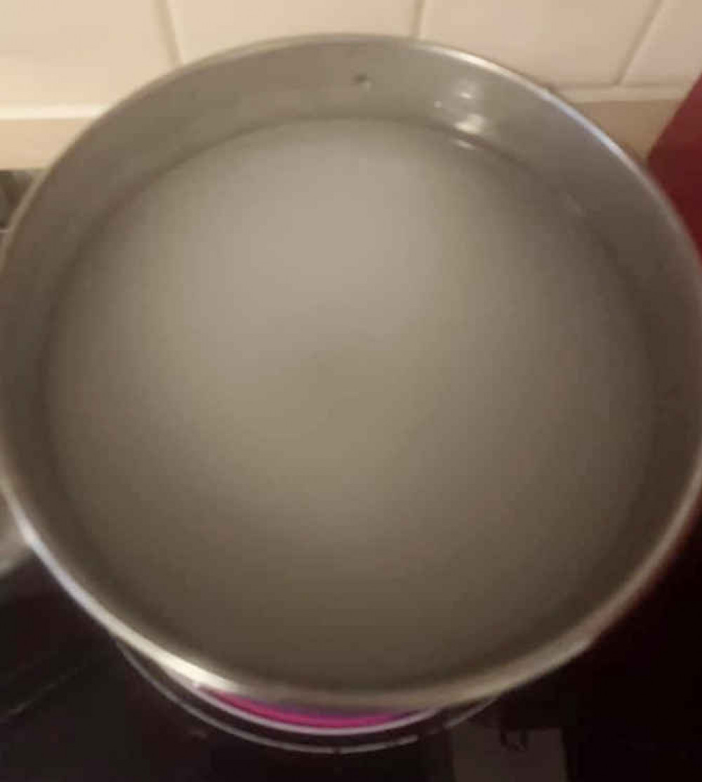 A resident posted this picture of a pan of 'discoloured' water