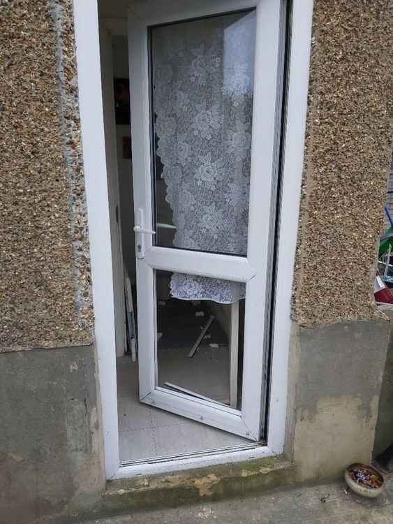 Police battered through this door to gain entry and found drugs and weapons.