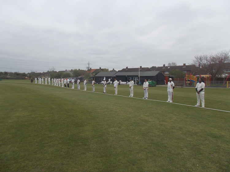 Cricketers from Belhus CC and Luton Caribbean CC, plus officials, show their respect