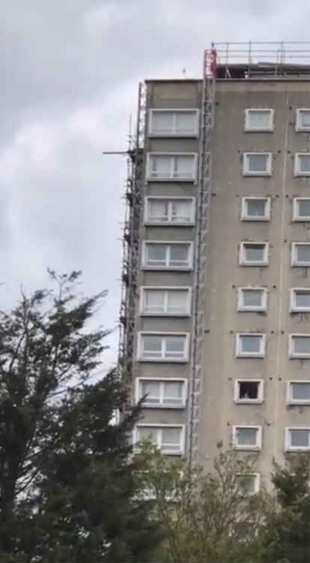 A loose plank hangs precariously from Davall House yesterday evening